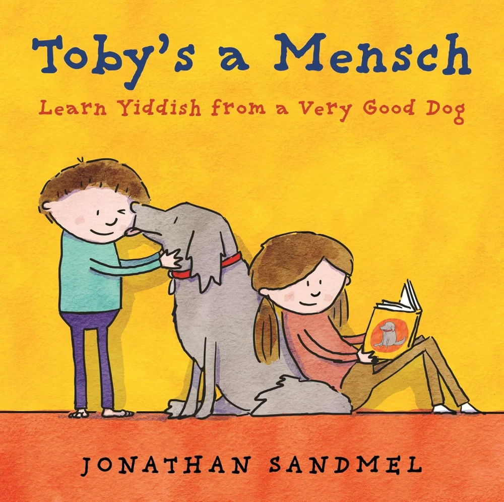 Cover of Toby's a Mensch: a three-legged dog hugged by two children on a sunny yellow background.